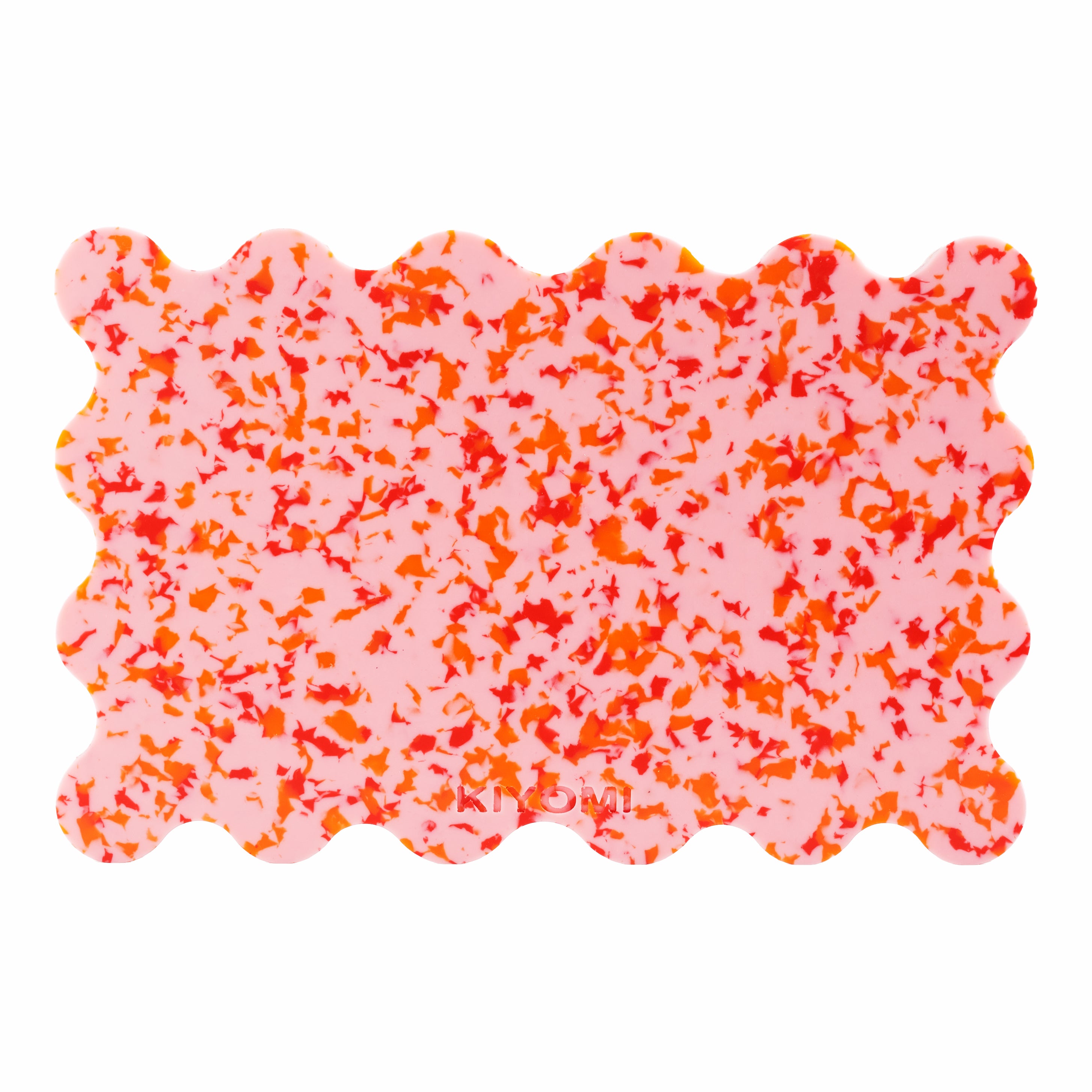 Blush pink scalloped cutting board with vibrant orange and red speckles, made from recycled BPA-free plastic